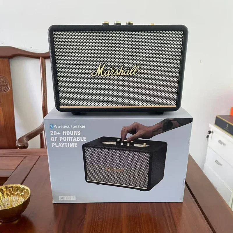 Marshall wireless speaker on top of its packaging box on a wooden table.