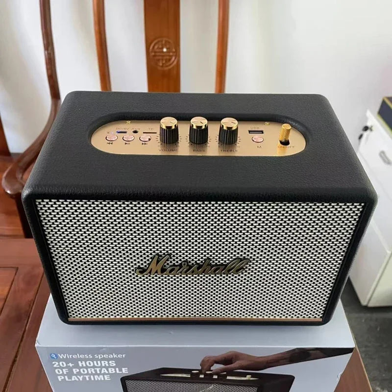 Black and gold Marshall speaker on a box with a blurred background