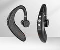 Black Bluetooth headset on a white background to put around the ear