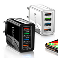 Black and white multi-port chargers with smartphone on a white background