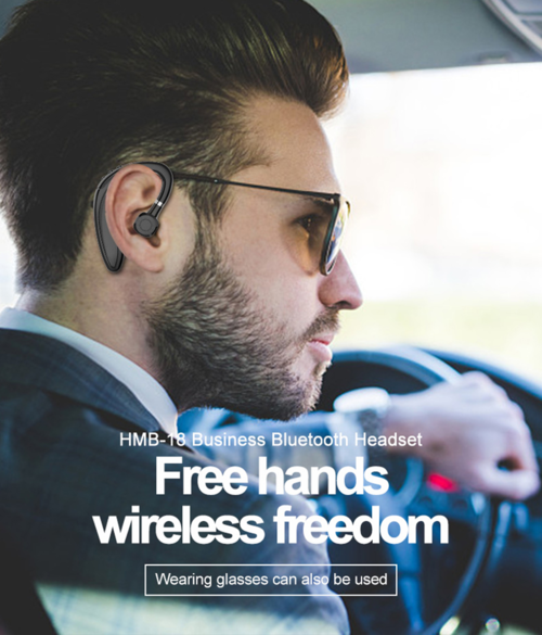 Man wearing a Bluetooth headset with text 'Free hands wireless freedom' in a car.